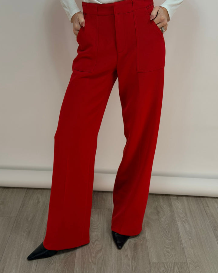 Red pants worn by a person on a plain background